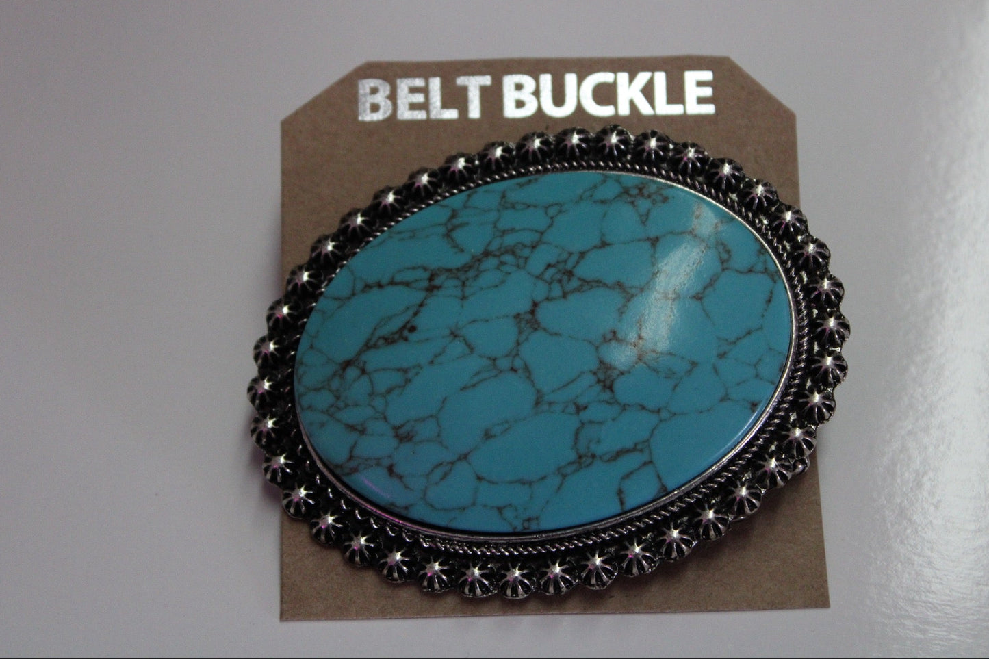 Turquoise belt buckle on with silver detailing the outer edge.